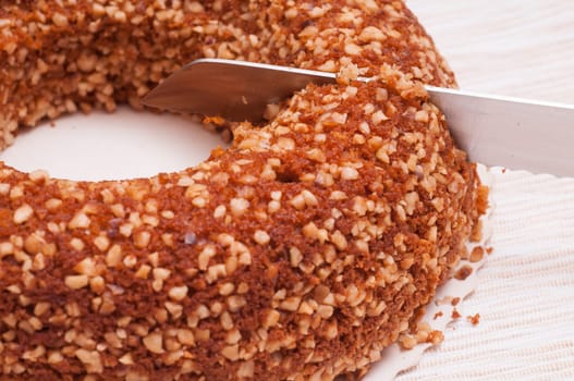 Nut cake is cut from the kitchen knife