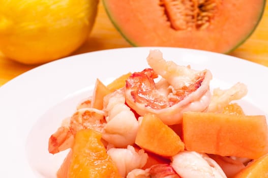 Plate of fried prawns and Charentais melon