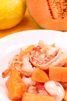 Plate of scampi with melon in portrait format