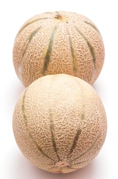 Charentais melons in portrait format on white background