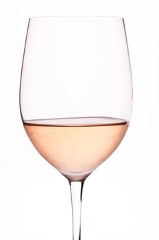 Rosé wine in backlight and wine glass