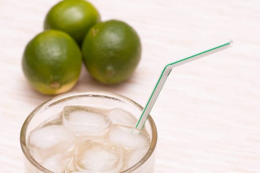 Cocktail with ice cubes and straw