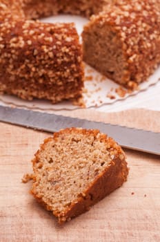 Piece of nut cake and cake knife in the background
