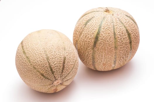 Two Charentais melons on white background
