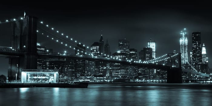 Manhattan skyline by night from Brooklyn bridge park - USA