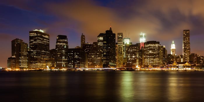 Manhattan skyline by night from Brooklyn bridge park - USA