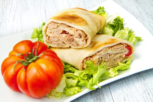tuna sandwich on fresh salad and tomato