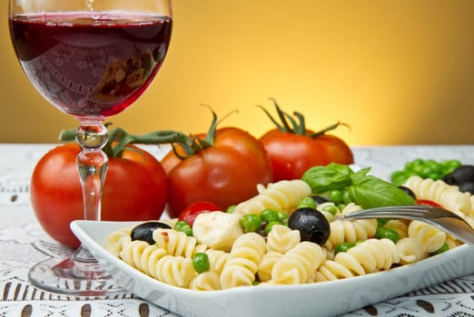 Pasta salad with mozzarella with a glass of red wine