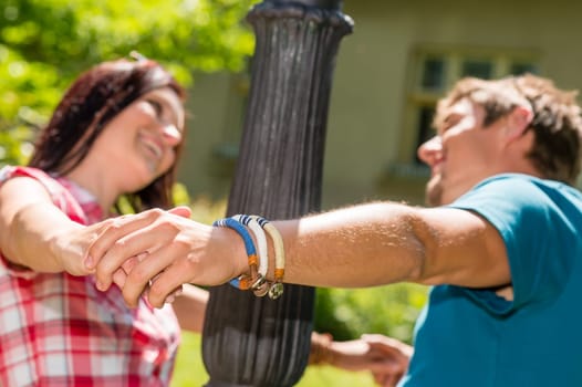 Playful couple having fun in the park happy smiling love