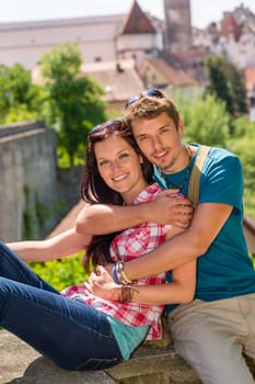 Young happy couple embracing enjoy city view smiling travel vacation