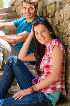 Young couple resting on stone stairs leisure time