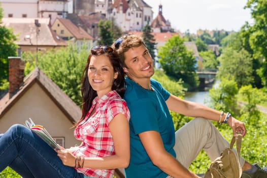Young happy couple sitting city view smiling travel vacation