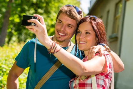 Young couple in love take picture of themselves outdoor