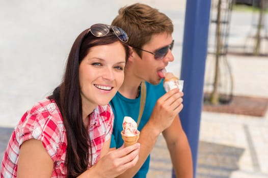 Young couple licking sweet ice cream on summer day