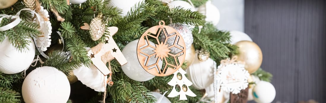 Handmade Christmas tree decoration hanging on Xmas tree with dried apple, leather, and wooden toys.