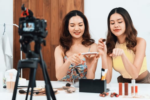 Woman influencer shoot live streaming vlog video review makeup uttermost social media or blog. Happy young girl with cosmetics studio lighting for marketing recording session broadcasting online.