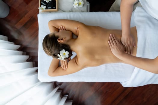 Panorama top view woman customer enjoying relaxing anti-stress spa massage and pampering with beauty skin recreation leisure in day light ambient salon spa at luxury resort or hotel. Quiescent