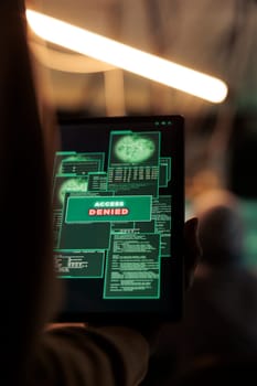 Access denied message on digital tablet, hacker failed database hacking, unsuccessful password cracking. Cybercrime, internet criminal using malicious software, stealing data at night time