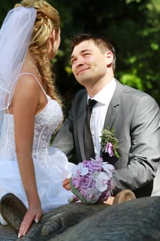 wedding time - bride and groom posing in park