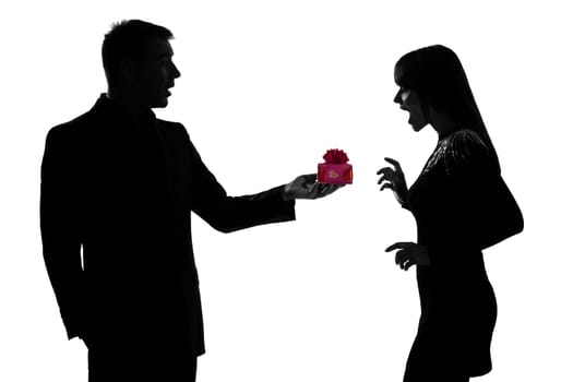 one caucasian couple man kneeling offering present gift and woman surprised in studio silhouette isolated on white background