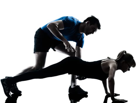 caucasian aerobics instructor  with mature woman exercising fitness workout in silhouette studio isolated on white background