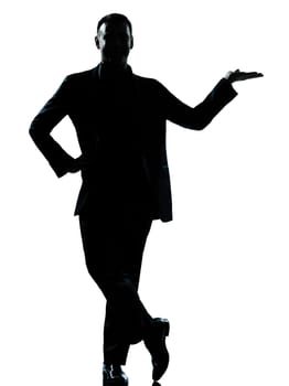 one caucasian business man silhouette standing hand open  Full length in studio isolated on white background
