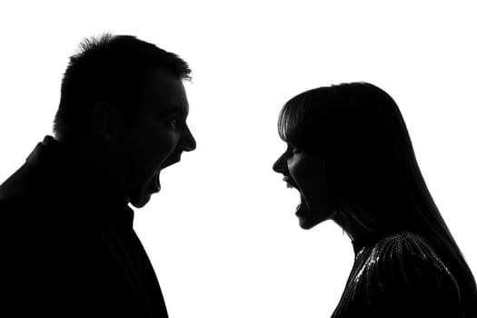 one caucasian couple man and woman face to face screaming shouting dipute in studio silhouette isolated on white background