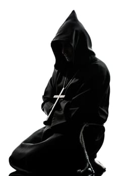 one caucasian man priest praying silhouette in studio isolated on white background