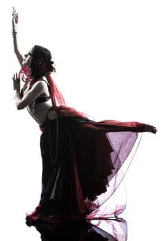 one arabic woman belly dancer dancing silhouette studio isolated on white background