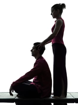 one man and woman perfoming thai massage in silhouette studio on white background