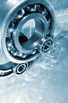 ball-bearings, gears mirrored in titanium background, metallic blue toning idea