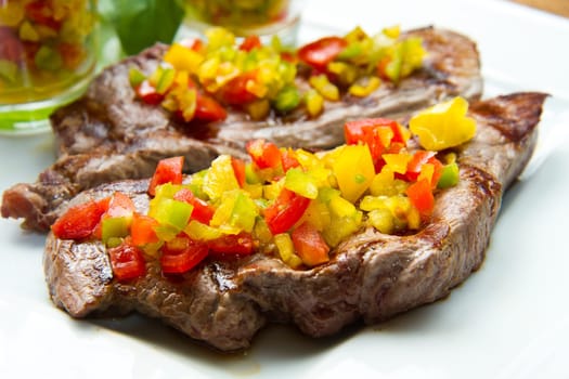 grilled steak meat with cut vegetables