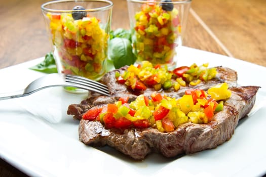 grilled steak meat with cut vegetables