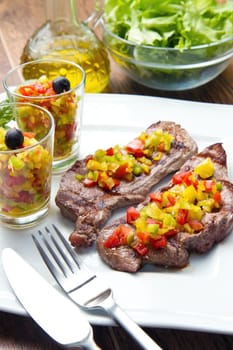 grilled steak meat with cut vegetables