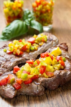 grilled steak meat with cut vegetables