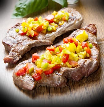 grilled steak meat with cut vegetables