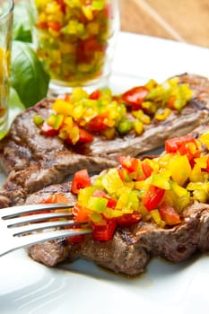 grilled steak meat with cut vegetables