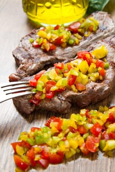 grilled steak meat with cut vegetables