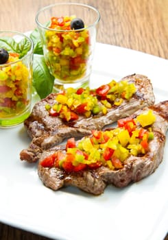 grilled steak meat with cut vegetables