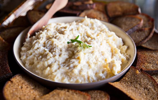 Bred and porridge in dish lay on table