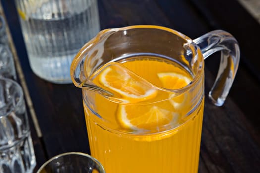 Juice of orange is on dark painted table