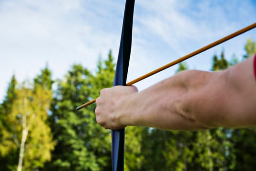 Man is ready to shoot from sport bow