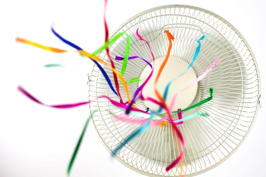 An electric fan blowing silk ribbons
