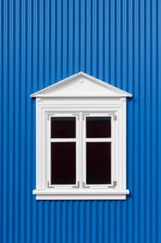 New blue corrugated wall with a white window