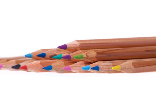 Colored crayons in a row as a close-up shot against white background