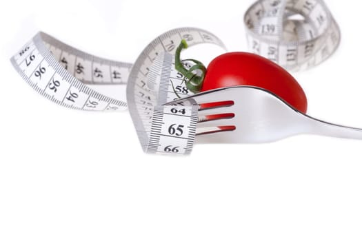 Healthy Eating - Weight Loss with Measure - Measuring Tape Guided by a Fork with a Tomato Against a White Background