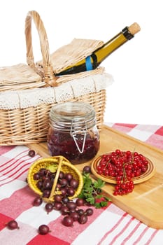 Jam with berries of red currant and gooseberry on the table