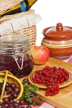 Jam with berries of red currant and gooseberry on the table