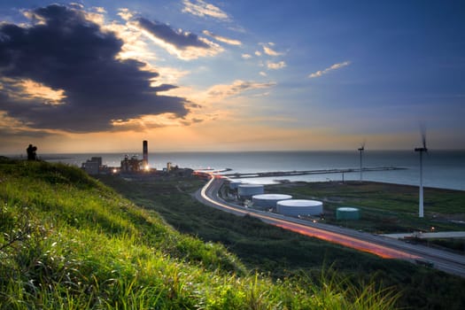 A road and windmills during sunset, made with a wide angle lens