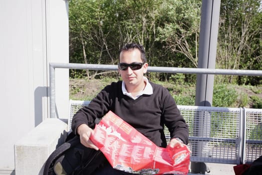 A shot of a handsome caucasian traveling man reading a map